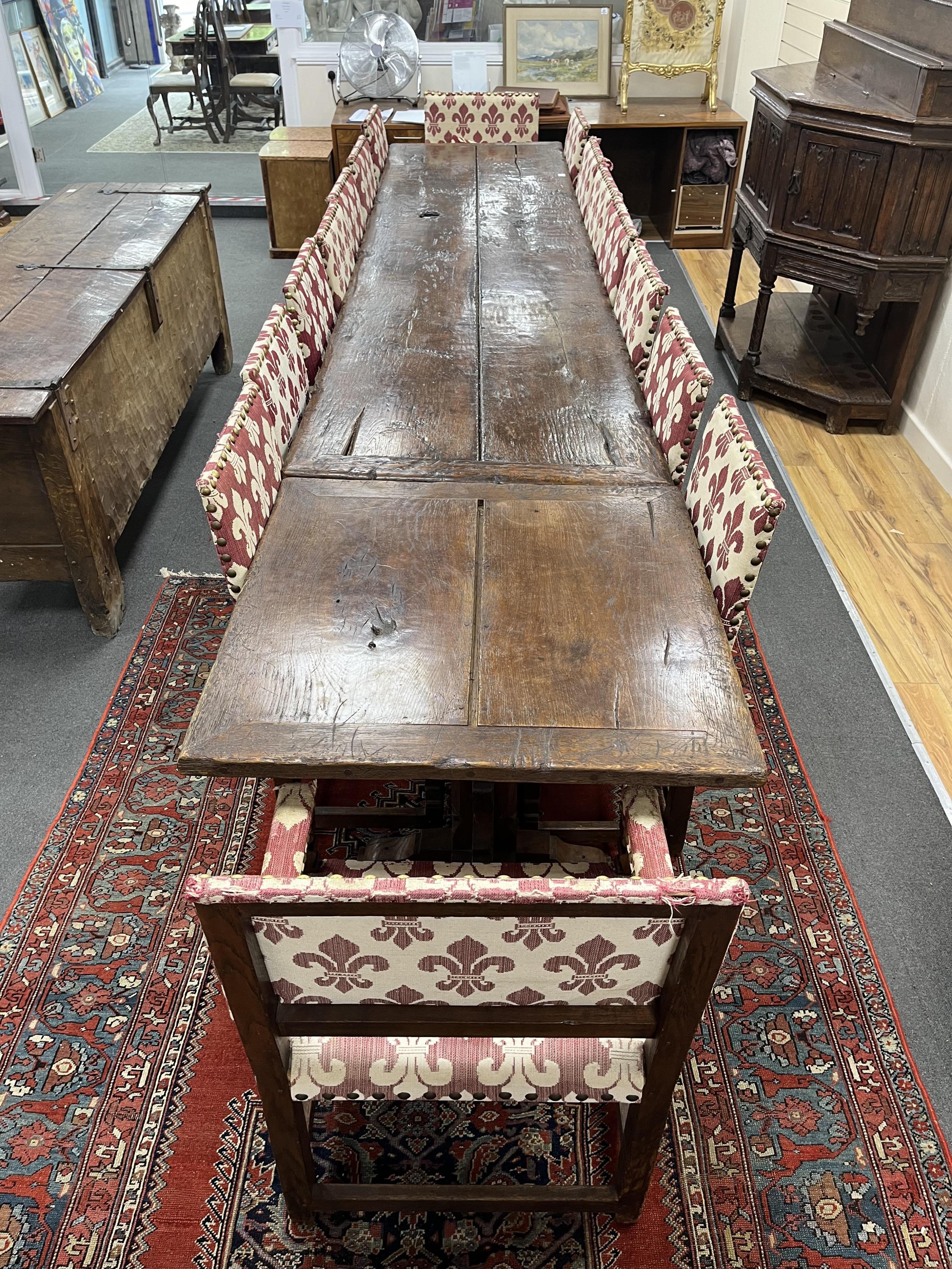A set of sixteen upholstered oak dining chairs, in 17th century style, two with arms. Condition - fair , Provenance - made for Brede Place, Brede, Rye, East Sussex. Commissioned from Stuart interiors who have furnished s